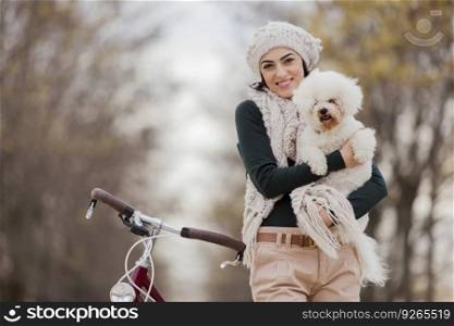 Young woman with a bicycle and a cute dog