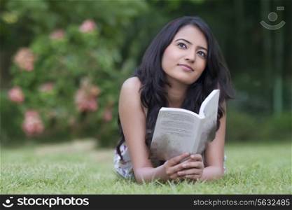 Young woman with a book thinking
