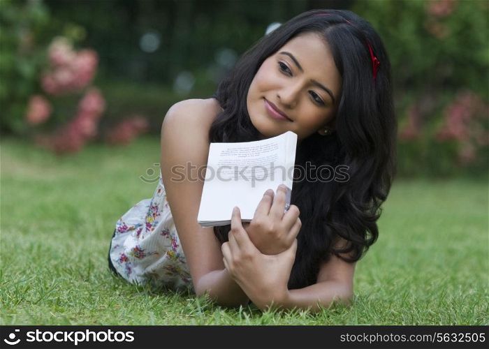 Young woman with a book thinking