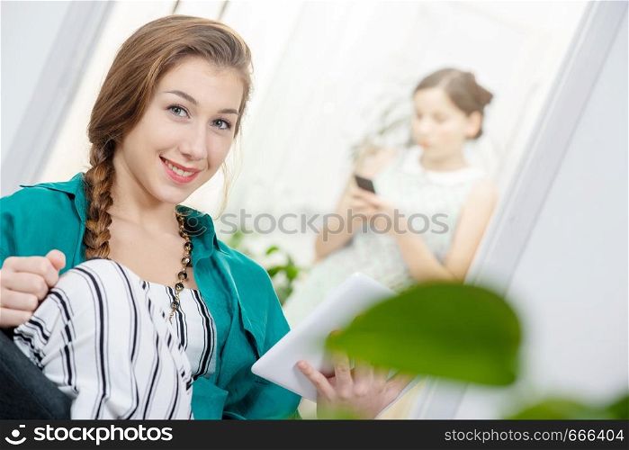 young woman with a braid using a tablet computer