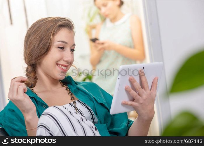 young woman with a braid using a tablet computer