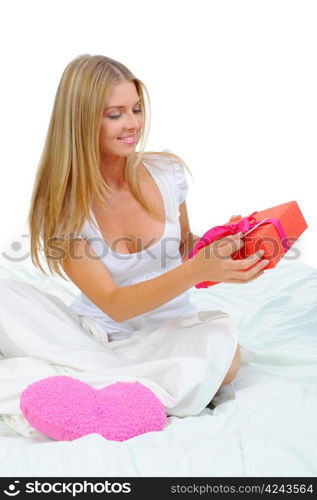 young woman with a gift box in the bed. Isolated on white background