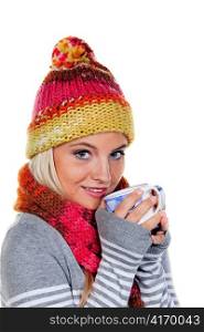 young woman with a hood warms up with hot tea.
