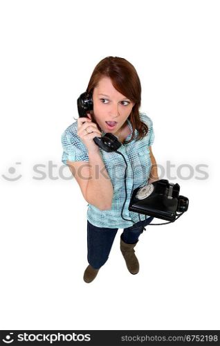 Young woman with a landline phone