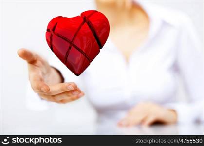 Young woman with a red heart in her hand