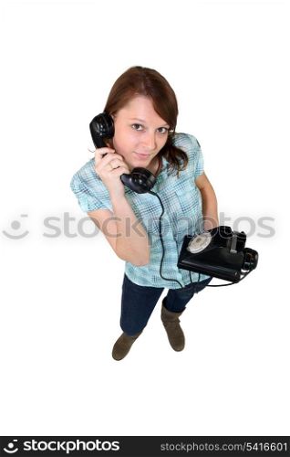 Young woman with a retro phone