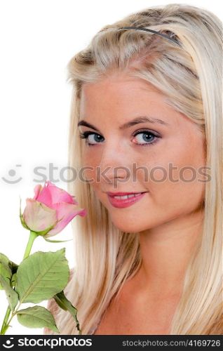 young woman with a rose at the smell it.