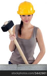 Young woman with a sledgehammer