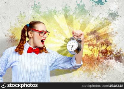 Young woman with an old-fashioned alarm clock