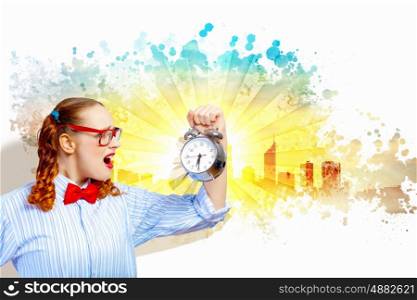 Young woman with an old-fashioned alarm clock