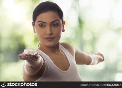 Young woman with arms outstretched against glass