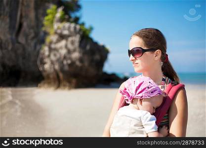 Young woman with baby at the beach