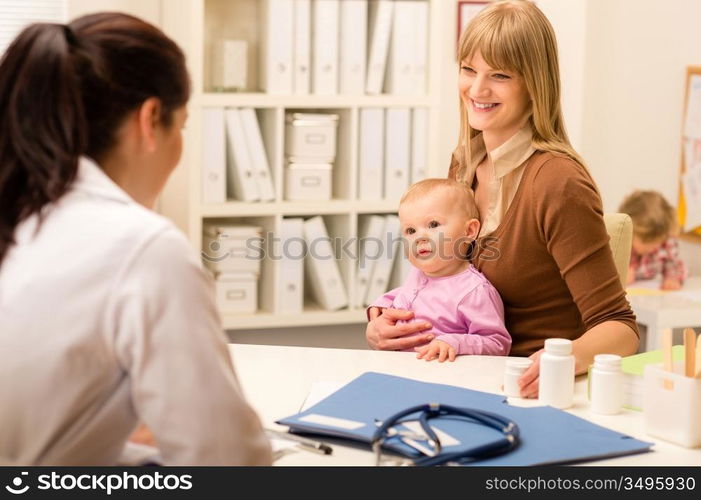 Young woman with baby girl visit pediatrician office for medical check-up