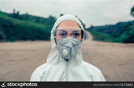 Young woman with bacteriological protection suit and protective mask. Woman with bacteriological protection suit