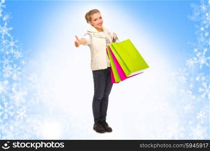 Young woman with bags on blue snowy background