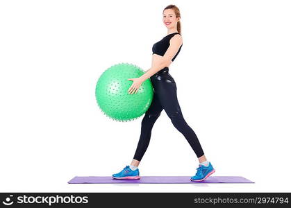 Young woman with ball exercising on white