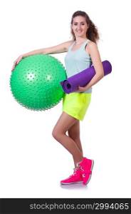 Young woman with ball exercising on white