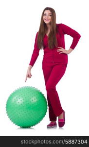 Young woman with ball exercising on white