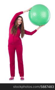 Young woman with ball exercising on white