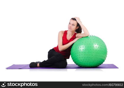 Young woman with ball exercising on white