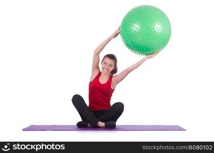 Young woman with ball exercising on white