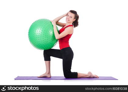 Young woman with ball exercising on white