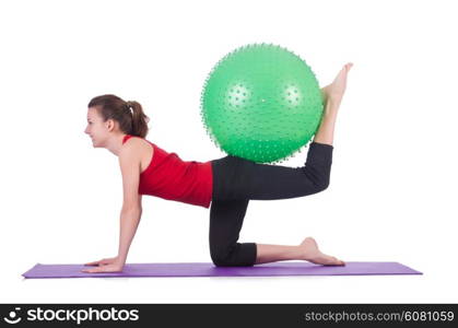 Young woman with ball exercising on white