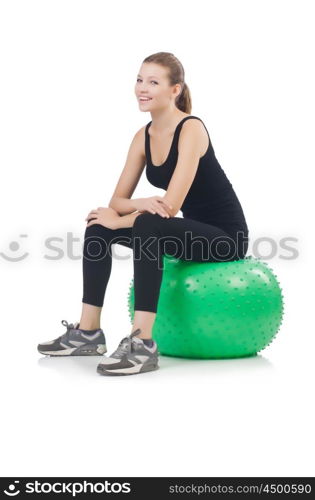 Young woman with ball exercising on whitee