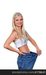 young woman with big pants after a successful diet: