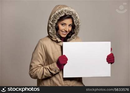 Young woman with bill board over colored background