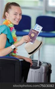young woman with boarding passes at the departure hall