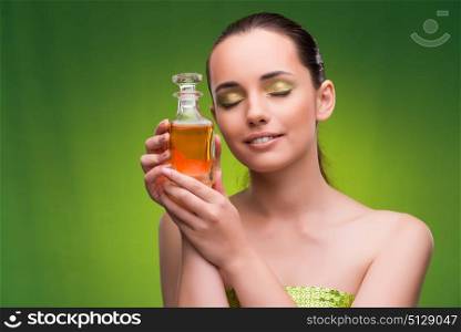 Young woman with bottle of perfume