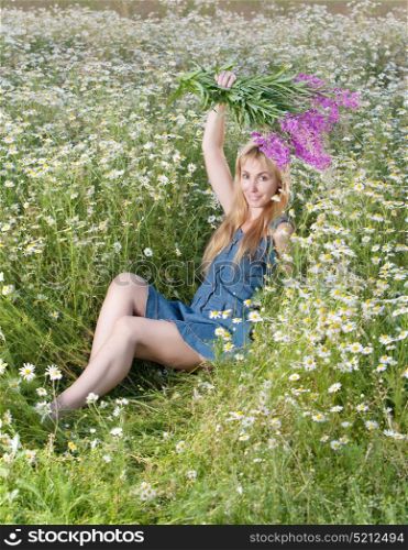 young woman with bouquet of firetop flower in the field