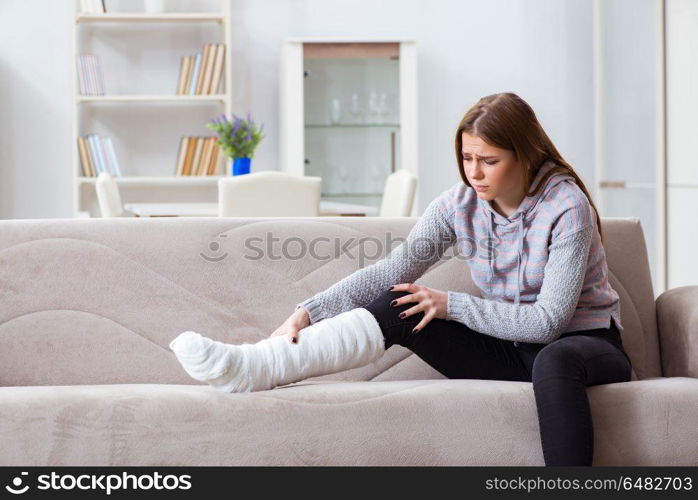 Young woman with broken leg at home