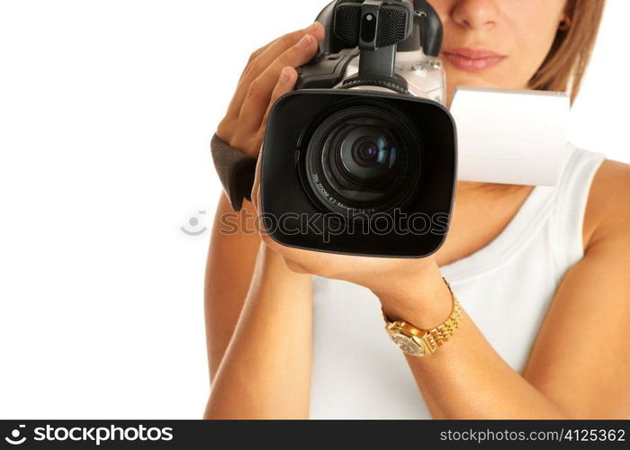 young woman with camcorder, selective focus on lens