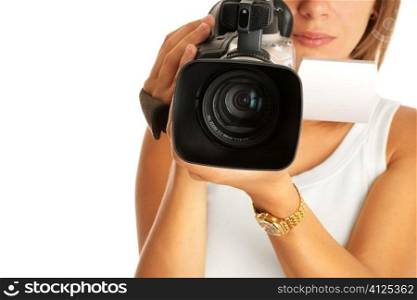 young woman with camcorder, selective focus on lens