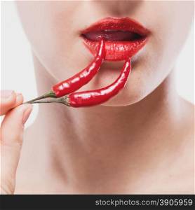 Young woman with chili pepper isolated on white