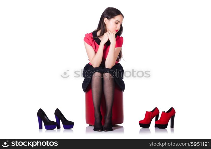 Young woman with choice of shoes on white