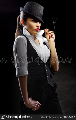 Young woman with cigar on black