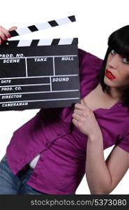 Young woman with cinema clap