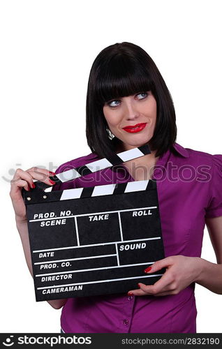 Young woman with clap of cinema