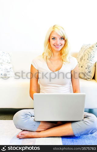 Young woman with computer at home