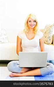 Young woman with computer at home