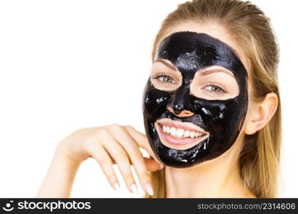 Young woman with cosmetic on face, carbo detox black peel off mask. Spa treatment. Skincare.. Woman with black peel off mask on face