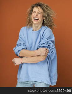 young woman with curly blonde hair smiling