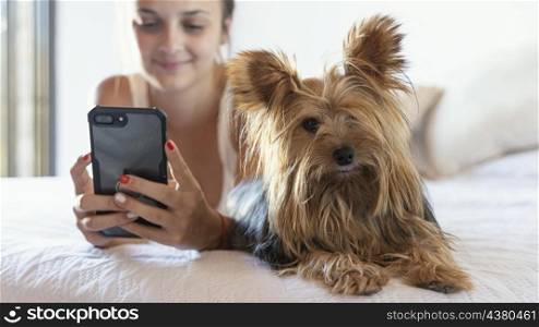 young woman with dog taking selfie