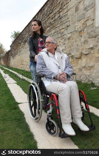 Young woman with elderly woman in wheelchair