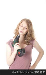 young woman with electric drill against white background