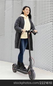 young woman with electric scooter