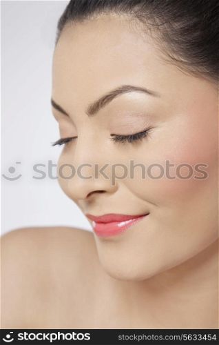 Young woman with eyes closed smiling